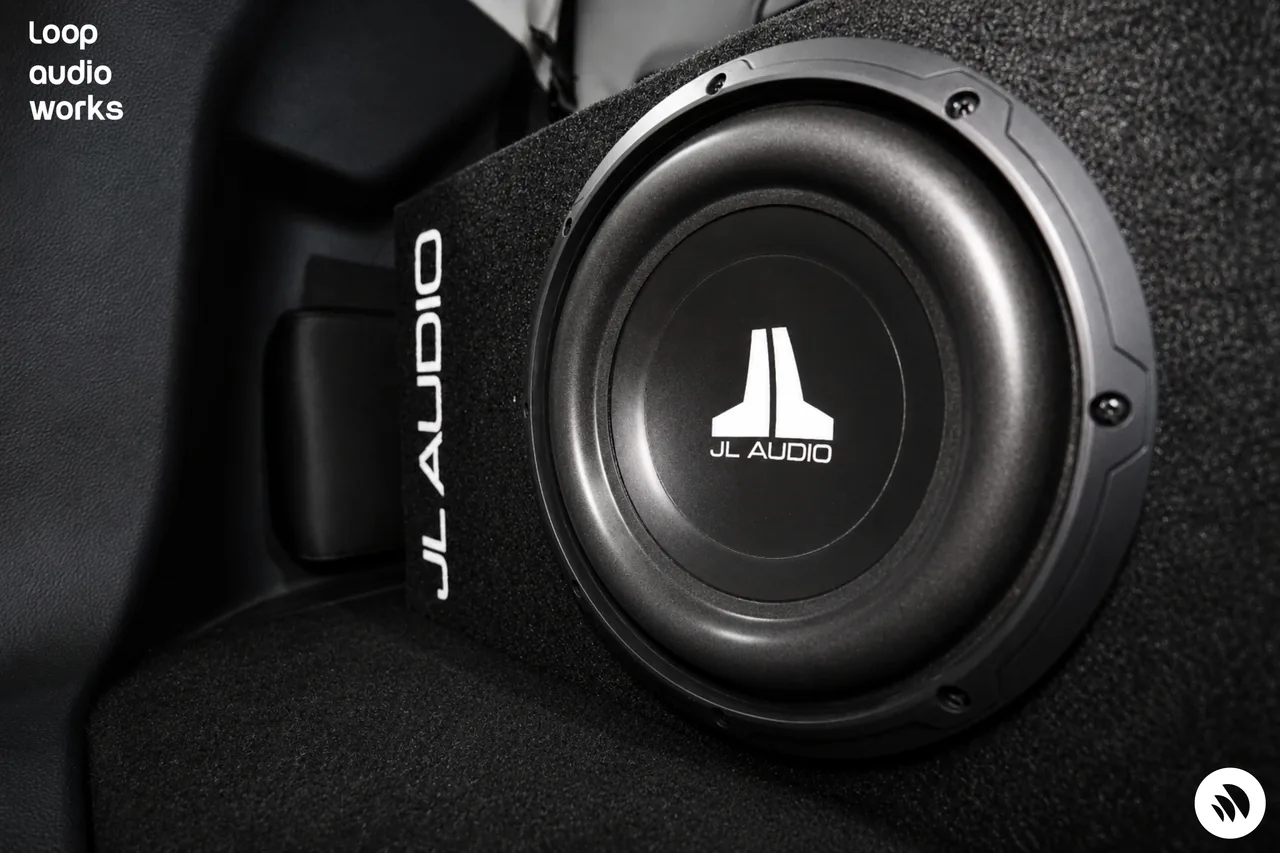JL Audio subwoofer installed as part of a custom car audio system.