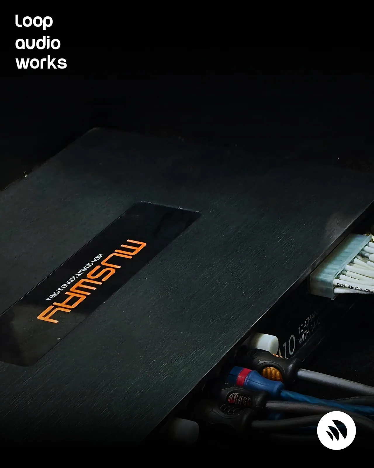 A Musway amplifier mounted and wired in a car audio installation.