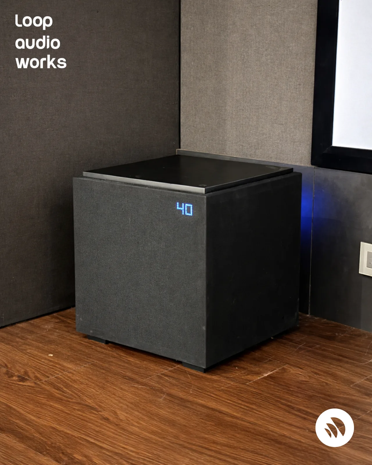 Custom-built subwoofer enclosure installed in a treated home cinema room